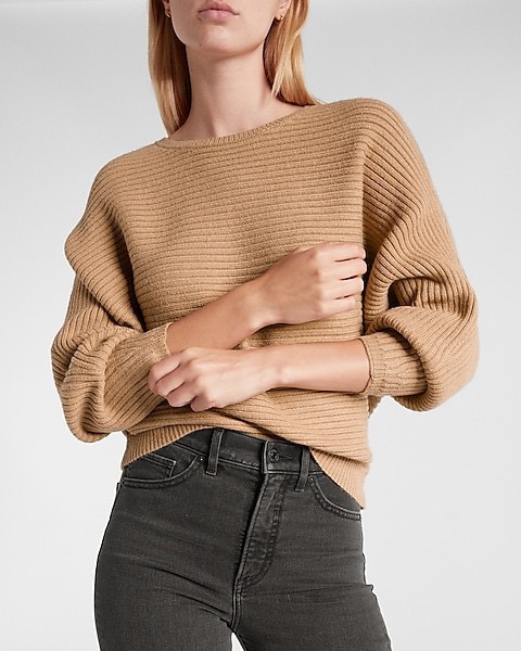 This cozy ribbed sweater with dolman sleeves is a must-have for fall. Mix and match with your favorite jewelry and throw on some jeans for a trendy look.